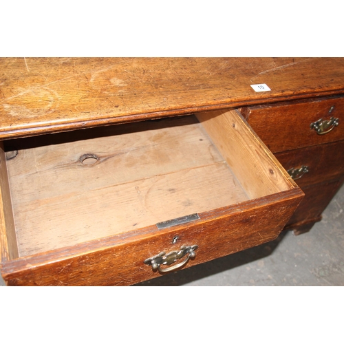 10 - An antique oak 2 over 2 chest of drawers with brass handles and bracket feet, approx 110cm wide