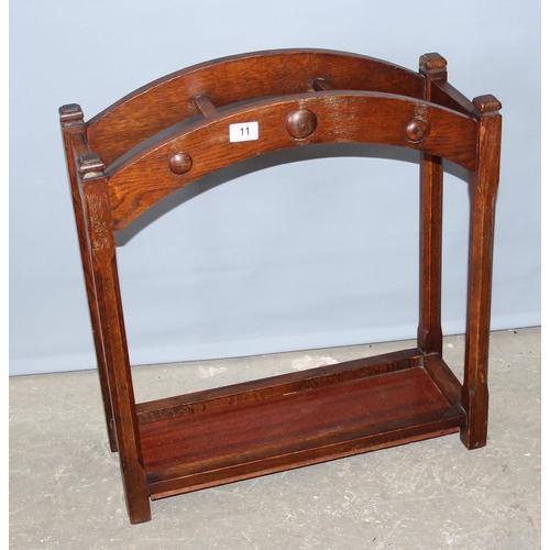 11 - An early 20th century oak stick stand, approx 60cm wide