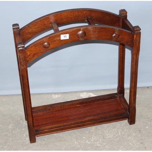 11 - An early 20th century oak stick stand, approx 60cm wide