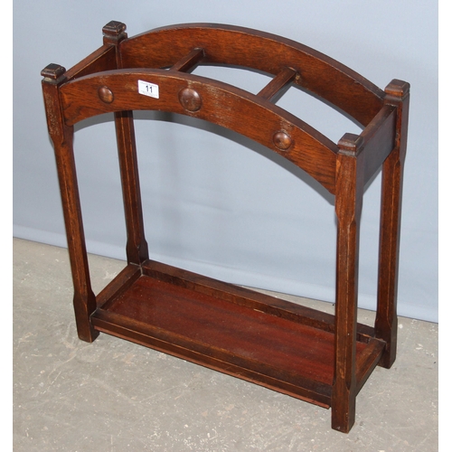 11 - An early 20th century oak stick stand, approx 60cm wide