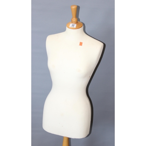 22 - A life size female mannequin on wooden base