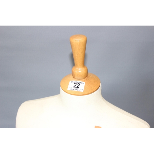 22 - A life size female mannequin on wooden base