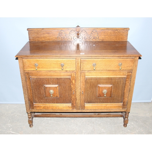 30 - A vintage oak sideboard, 2 drawers over 2 cupboards with carved back, approx 122cm wide