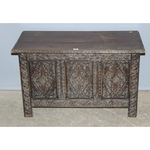 34 - An antique carved oak coffer, approx 100cm wide