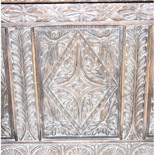 34 - An antique carved oak coffer, approx 100cm wide