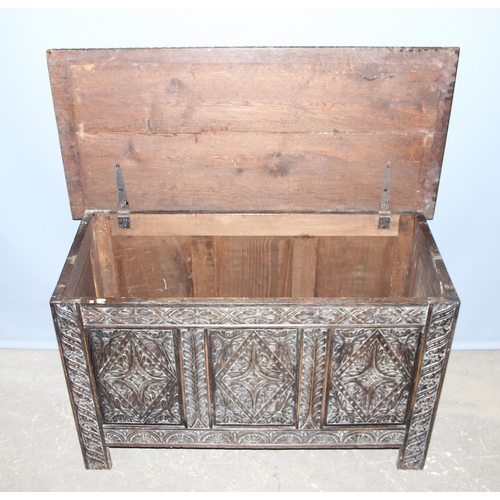 34 - An antique carved oak coffer, approx 100cm wide