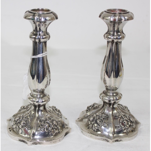 1029 - A pair of mid-19th century Austrian silver candlesticks with embossed floral decoration, each approx... 