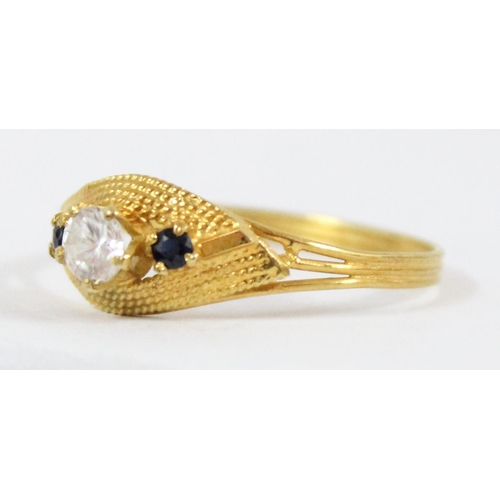 1101 - An 18ct gold ring with retro setting, central white stone flanked by 2 small blue sapphires, approx ... 