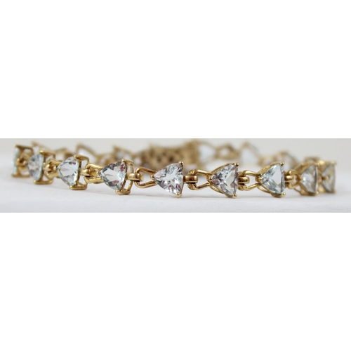 1112 - An Italian 9ct gold retro style tennis bracelet set with triangular shaped white/ light blue stones,... 