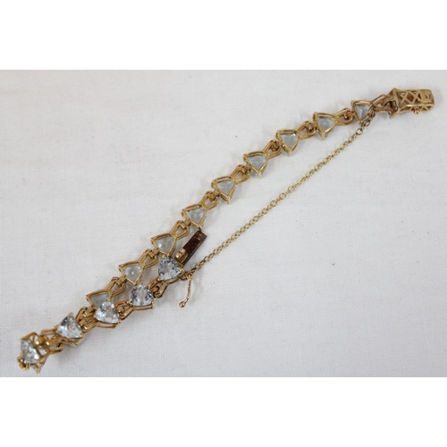 1112 - An Italian 9ct gold retro style tennis bracelet set with triangular shaped white/ light blue stones,... 