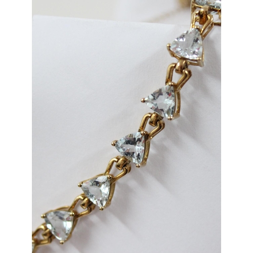 1112 - An Italian 9ct gold retro style tennis bracelet set with triangular shaped white/ light blue stones,... 