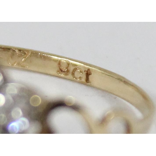 1114 - 9ct gold and floral set ring, approx size P, approx 1.05g gross