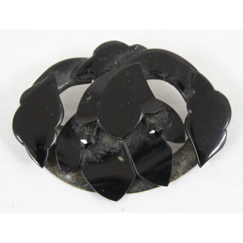 1130 - A Victorian mourning brooch, possibly Whitby Jet, formed as a flower