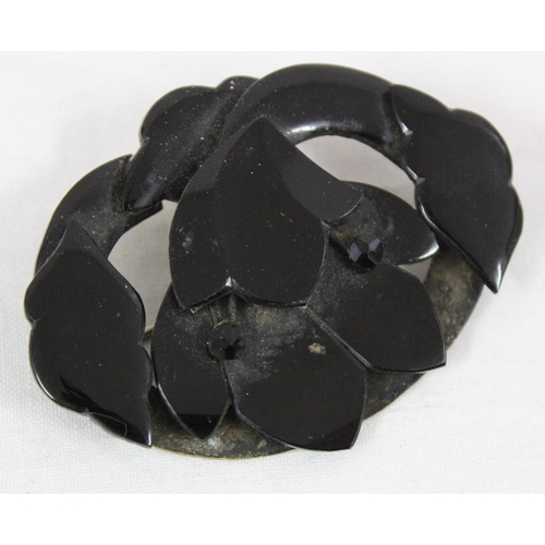 1130 - A Victorian mourning brooch, possibly Whitby Jet, formed as a flower