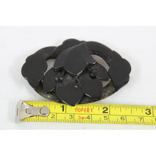 1130 - A Victorian mourning brooch, possibly Whitby Jet, formed as a flower