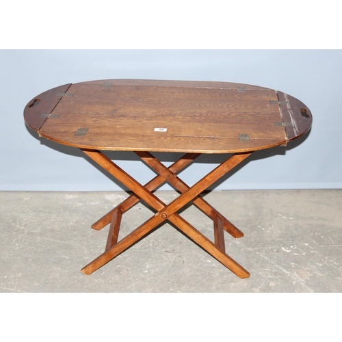 39 - An early 20th century folding oak butler's tray table on stand, approx 97cm wide