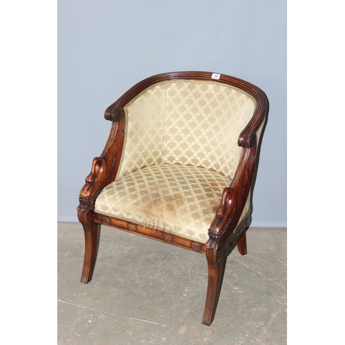 44 - An antique style upholstered tub chair with carved swan neck arms