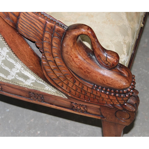 44 - An antique style upholstered tub chair with carved swan neck arms