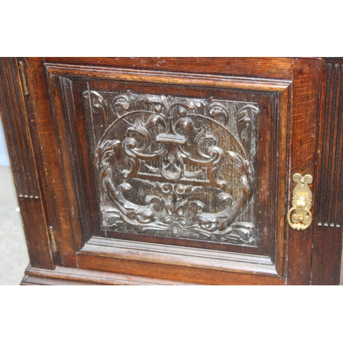 58 - An antique carved oak side cupboard with drawer, approx 55cm wide