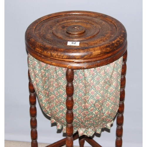 62 - An unusual vintage oak sewing box standing on bobbin turned legs, approx 35cm in diameter, with cont... 