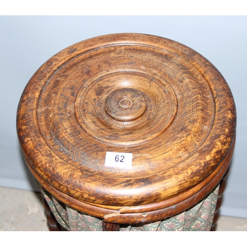 62 - An unusual vintage oak sewing box standing on bobbin turned legs, approx 35cm in diameter, with cont... 