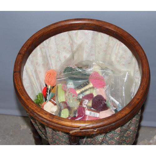 62 - An unusual vintage oak sewing box standing on bobbin turned legs, approx 35cm in diameter, with cont... 