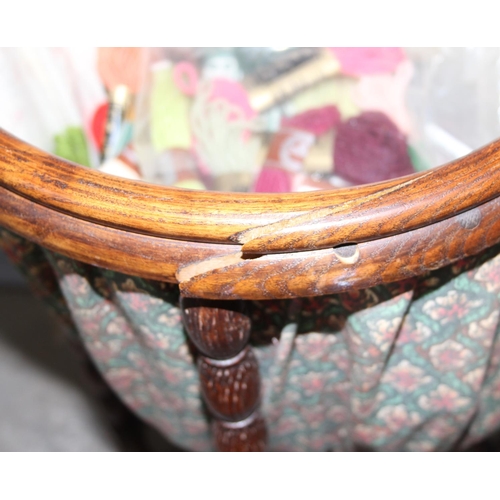 62 - An unusual vintage oak sewing box standing on bobbin turned legs, approx 35cm in diameter, with cont... 