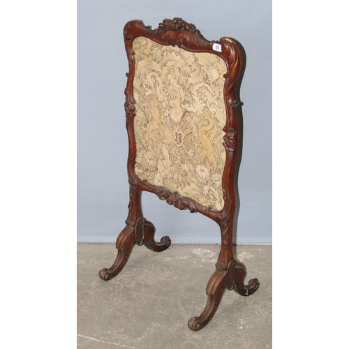 69 - An antique carved walnut fire screen with needlework panel, approx 110cm tall