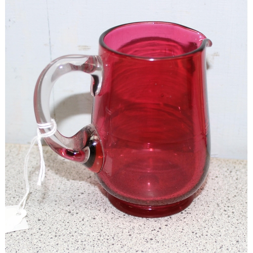 1627 - 3 pieces of antique cranberry glass, 2 mugs and a cream jug