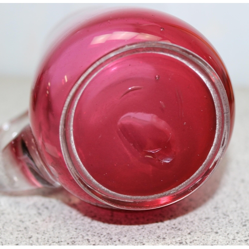 1627 - 3 pieces of antique cranberry glass, 2 mugs and a cream jug