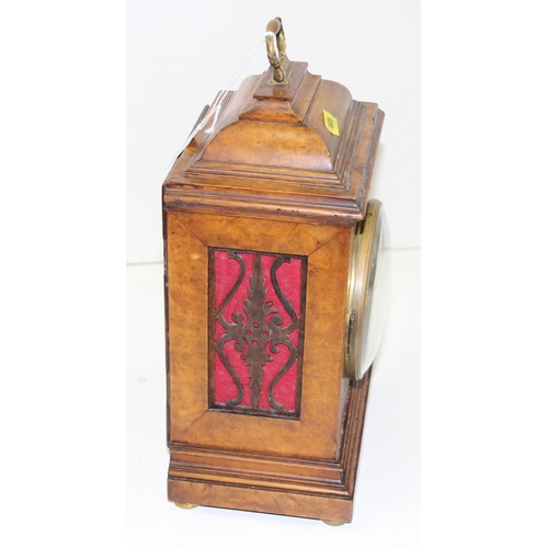 1319 - An early 20th century walnut cased bracket clock with fretwork panels, with pendulum but no key, Jap... 