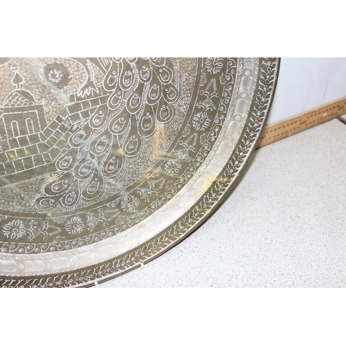 1767 - A vintage Benares brass tray with engraved decoration, approx 58cm wide