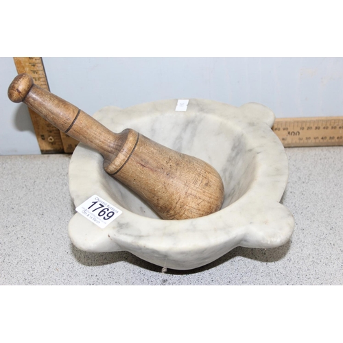 1769 - A large grey veined marble mortar and associated wooden pestle