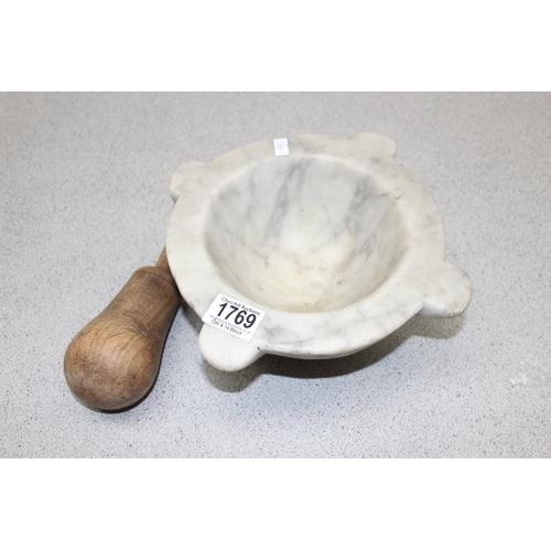 1769 - A large grey veined marble mortar and associated wooden pestle