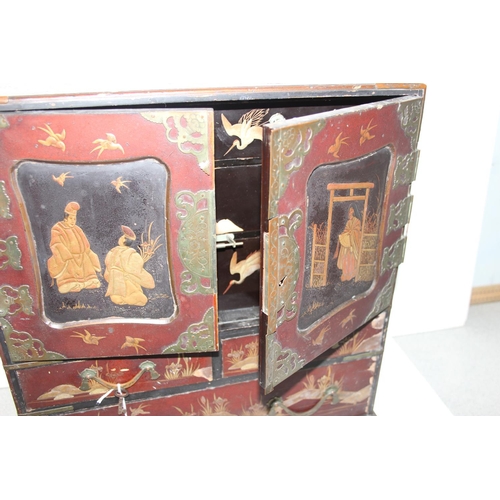 278 - An early 20th century Japanese lacquered table top cabinet, 2 short over one long drawer below 2 cab... 