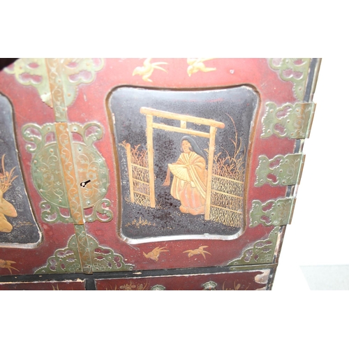 278 - An early 20th century Japanese lacquered table top cabinet, 2 short over one long drawer below 2 cab... 