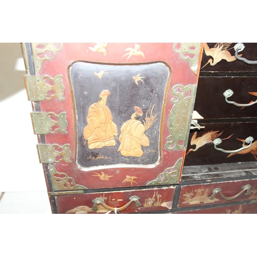 278 - An early 20th century Japanese lacquered table top cabinet, 2 short over one long drawer below 2 cab... 