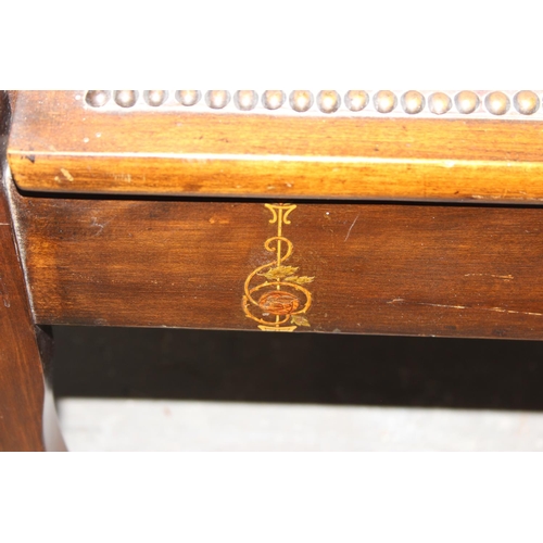 75 - An early 20th century lift top piano stool with studded leather top