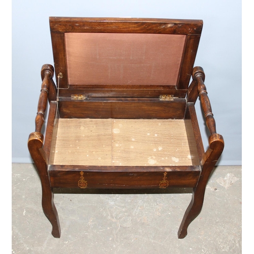 75 - An early 20th century lift top piano stool with studded leather top