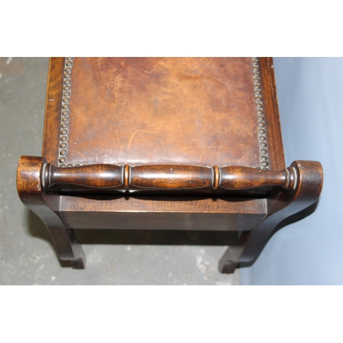 75 - An early 20th century lift top piano stool with studded leather top