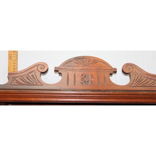 81 - Mahogany framed over mantle mirror with floral engraving and turned supports, approx width 110cm