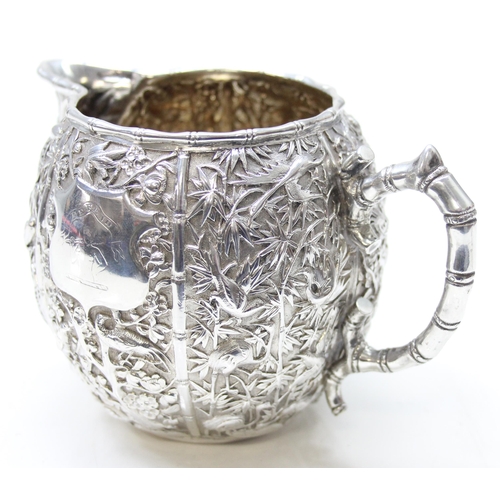 1048 - Chinese export silver milk or cream jug by Wang Hing, early 20th century, profusely decorated with b... 