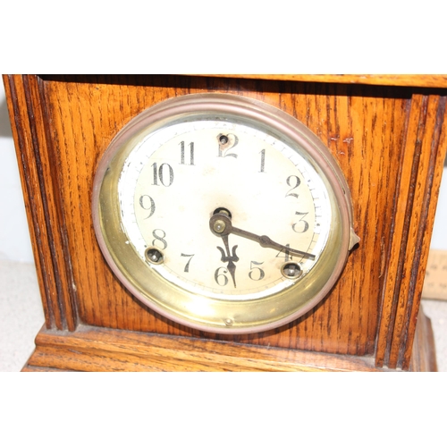 1330 - An early 20th century oak cased mechanical mantel clock with pendulum and key