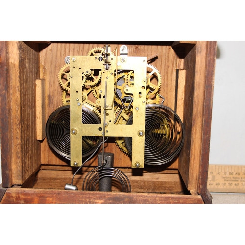 1330 - An early 20th century oak cased mechanical mantel clock with pendulum and key