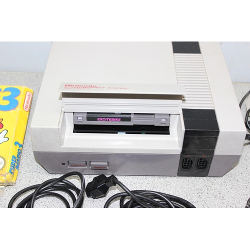 1563 - Nintendo NES with controllers and two games to include Super Mario Bros 3 & Excitebike