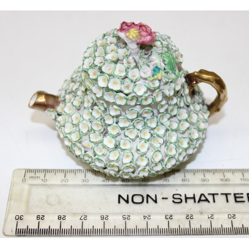 1634 - An extremely rare Rockingham squat pear shaped miniature teapot and cover, encrusted with florets an... 