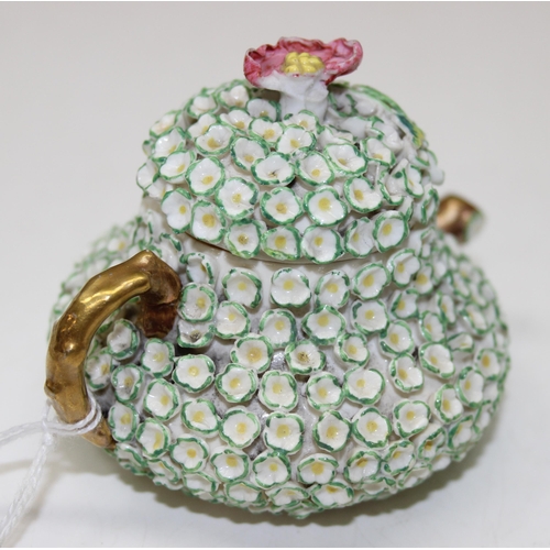 1634 - An extremely rare Rockingham squat pear shaped miniature teapot and cover, encrusted with florets an... 