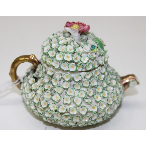 1634 - An extremely rare Rockingham squat pear shaped miniature teapot and cover, encrusted with florets an... 