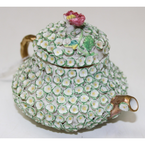 1634 - An extremely rare Rockingham squat pear shaped miniature teapot and cover, encrusted with florets an... 