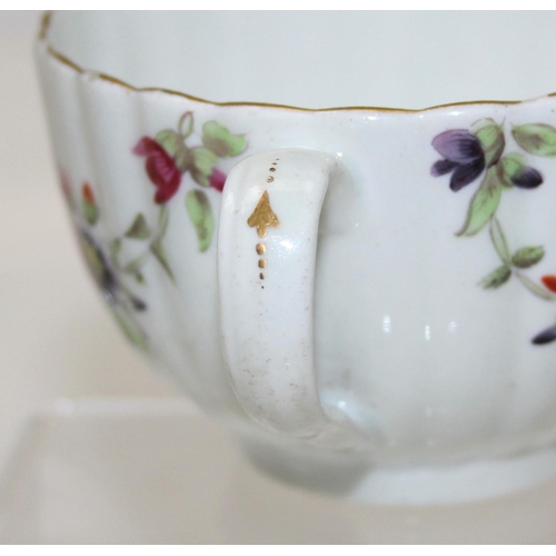 1643 - An 18th century porcelain tea cup and saucer decorated with floral sprigs, unmarked, the saucer appr... 